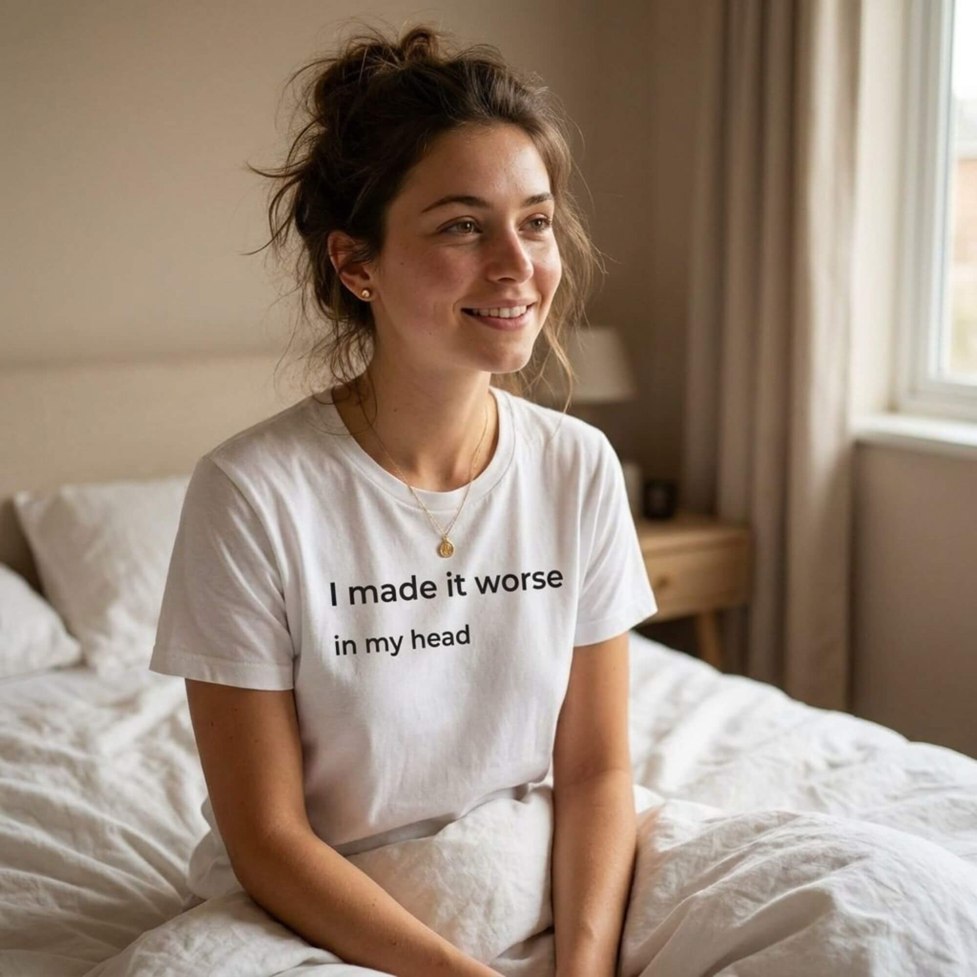 woman wearing i made it worse in my head white t-shirt sitting on bed — text & tone