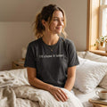 woman wearing i'll close it later dark ash t-shirt sitting on bed — text & tone