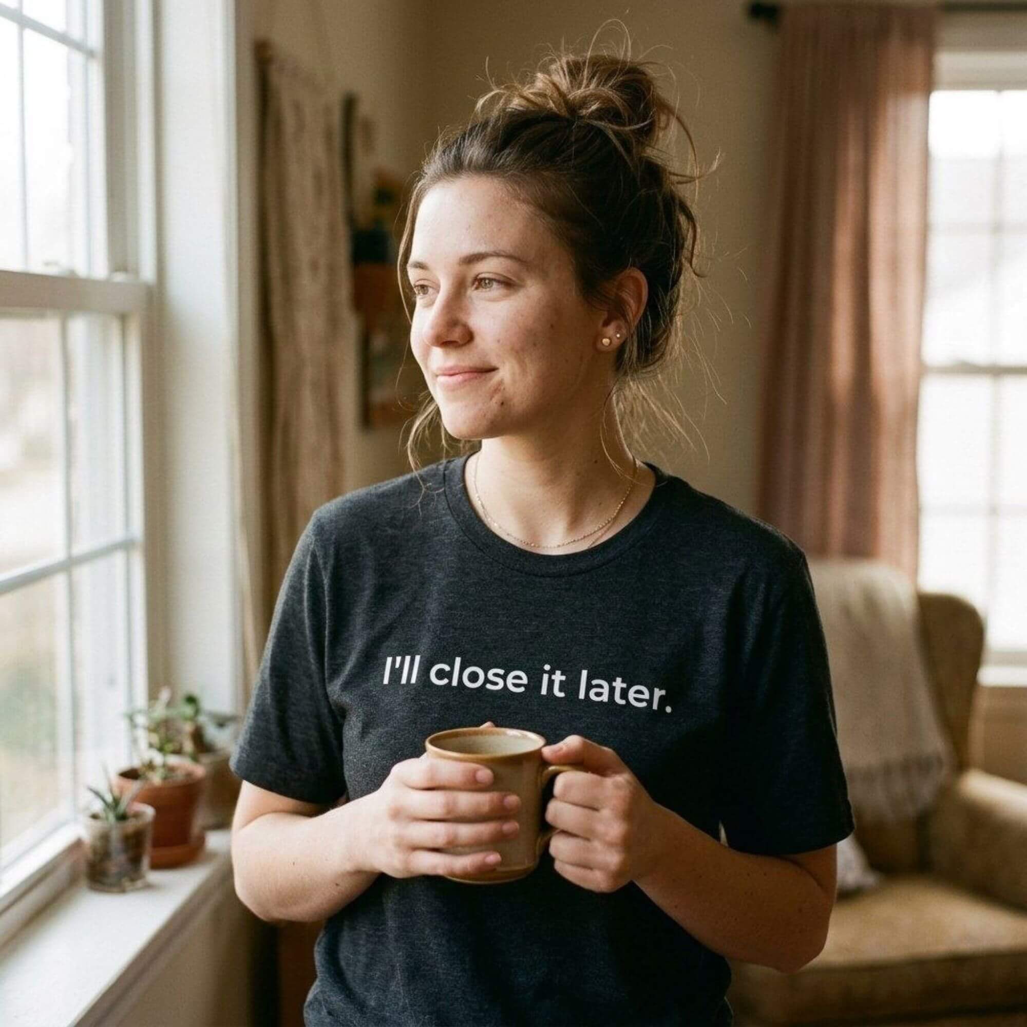 woman holding mug in i'll close it later black minimalist tee — text & tone