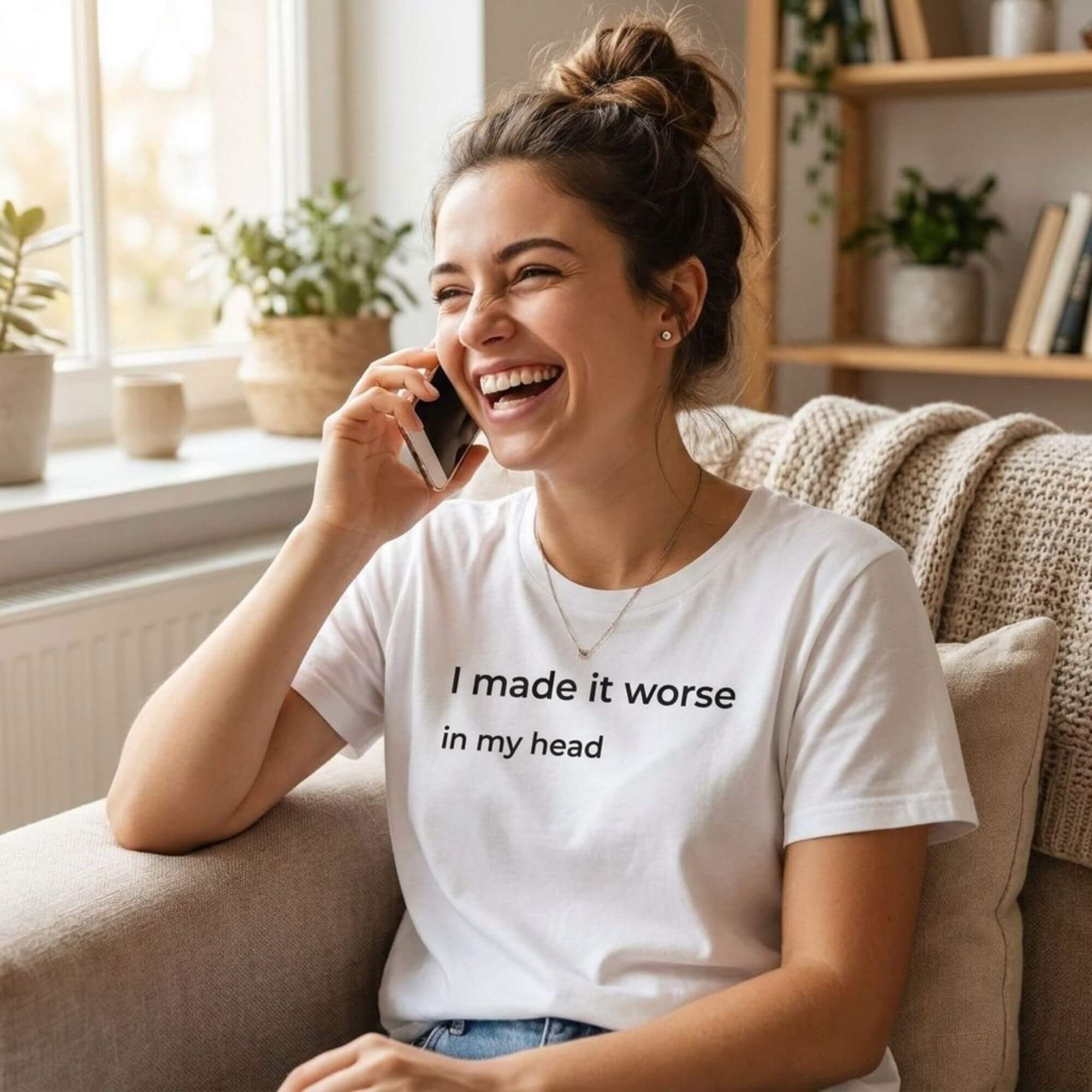 woman in i made it worse in my head white t-shirt laughing on sofa — text & tone