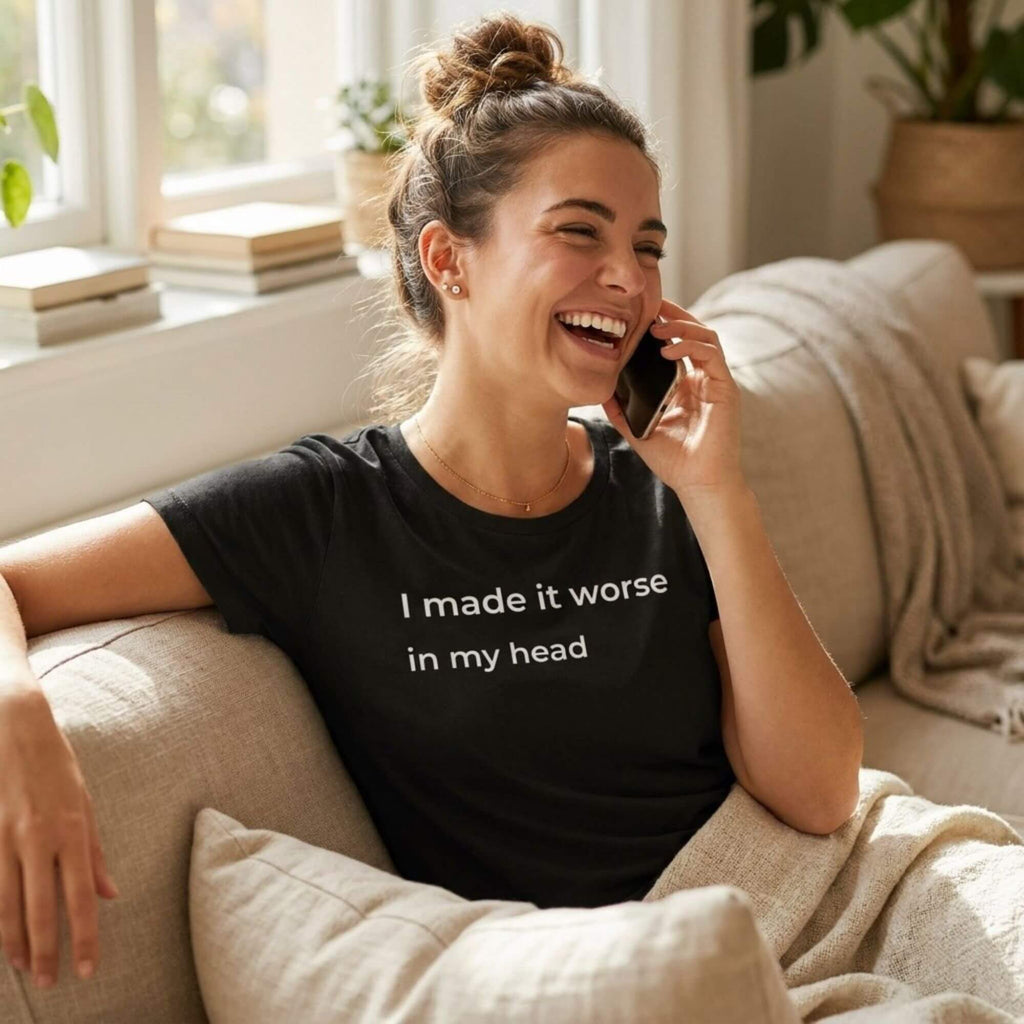 woman laughing on phone wearing i made it worse in my head black t-shirt — text & tone
