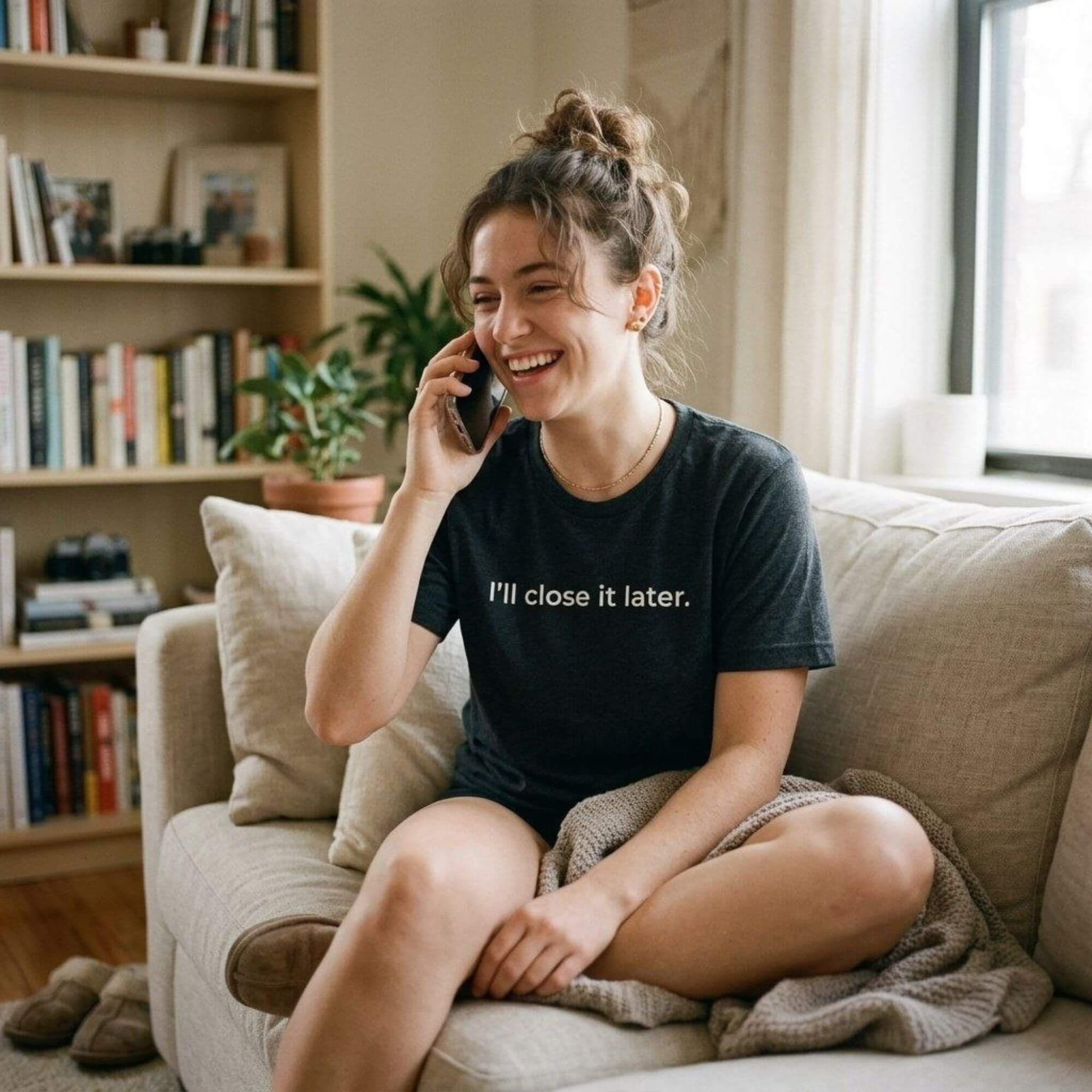 woman laughing on phone in dark ash slogan tee — i'll close it later — text & tone
