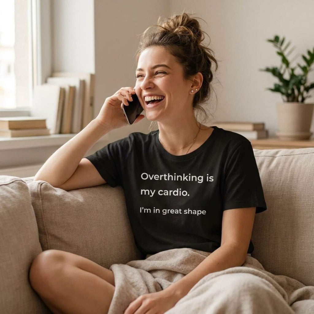 woman laughing on phone wearing overthinking is my cardio black t-shirt — text & tone