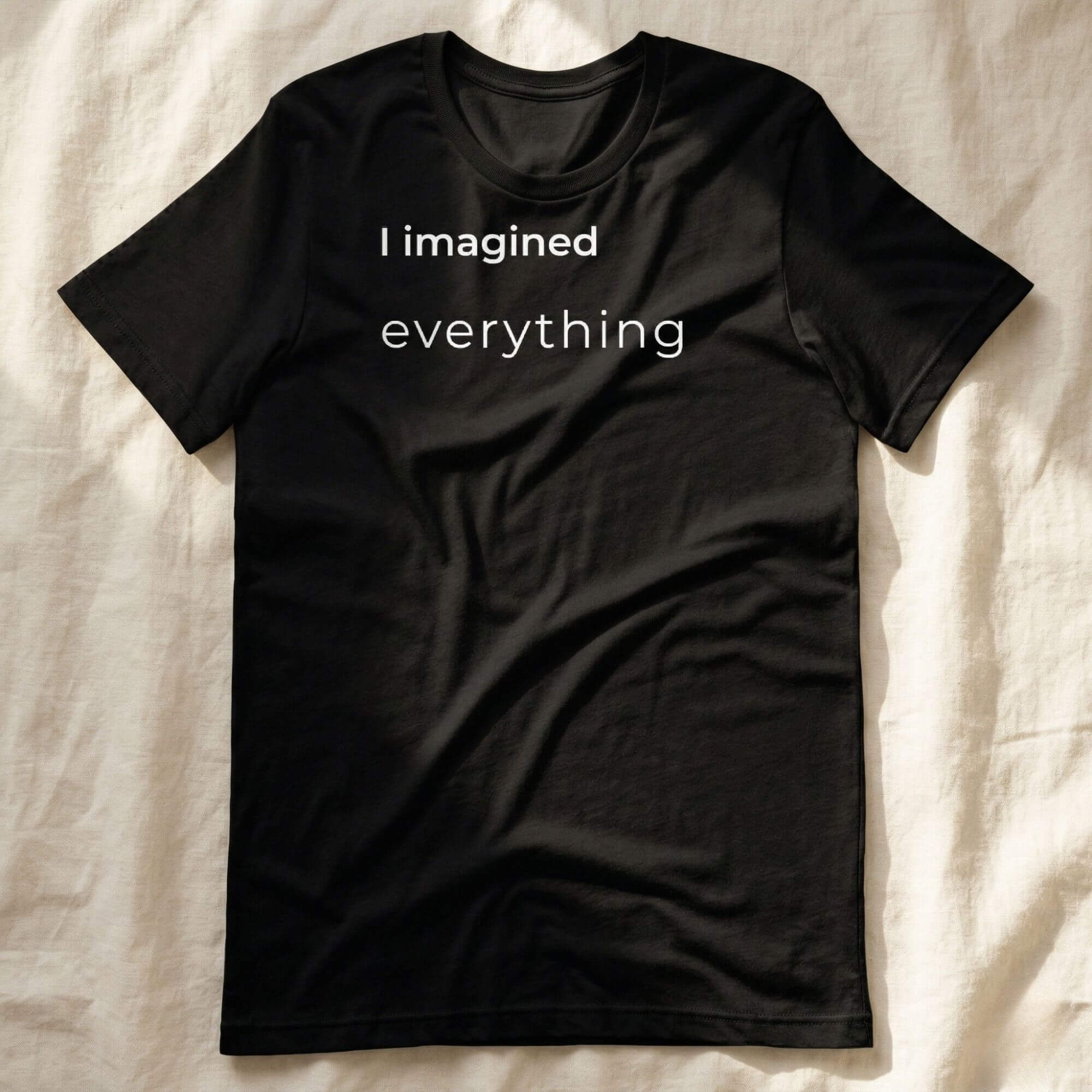 Black t-shirt with "I imagined everything" text, minimalist design