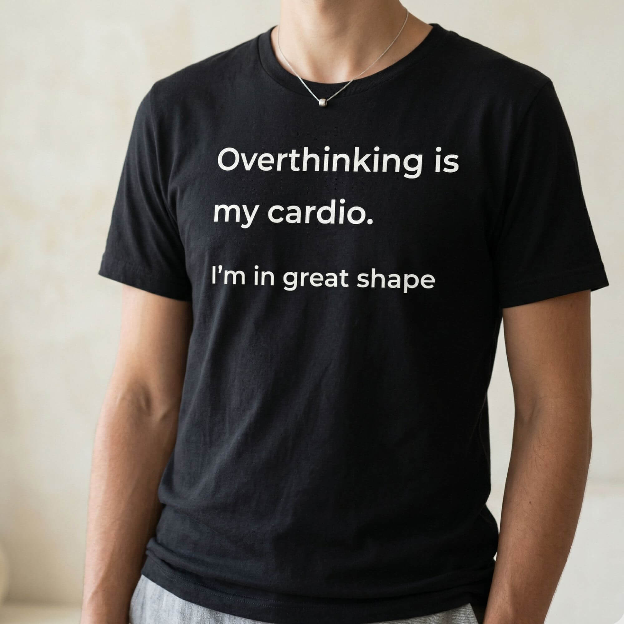 Black graphic t-shirt with overthinking quote worn by model, minimalist style