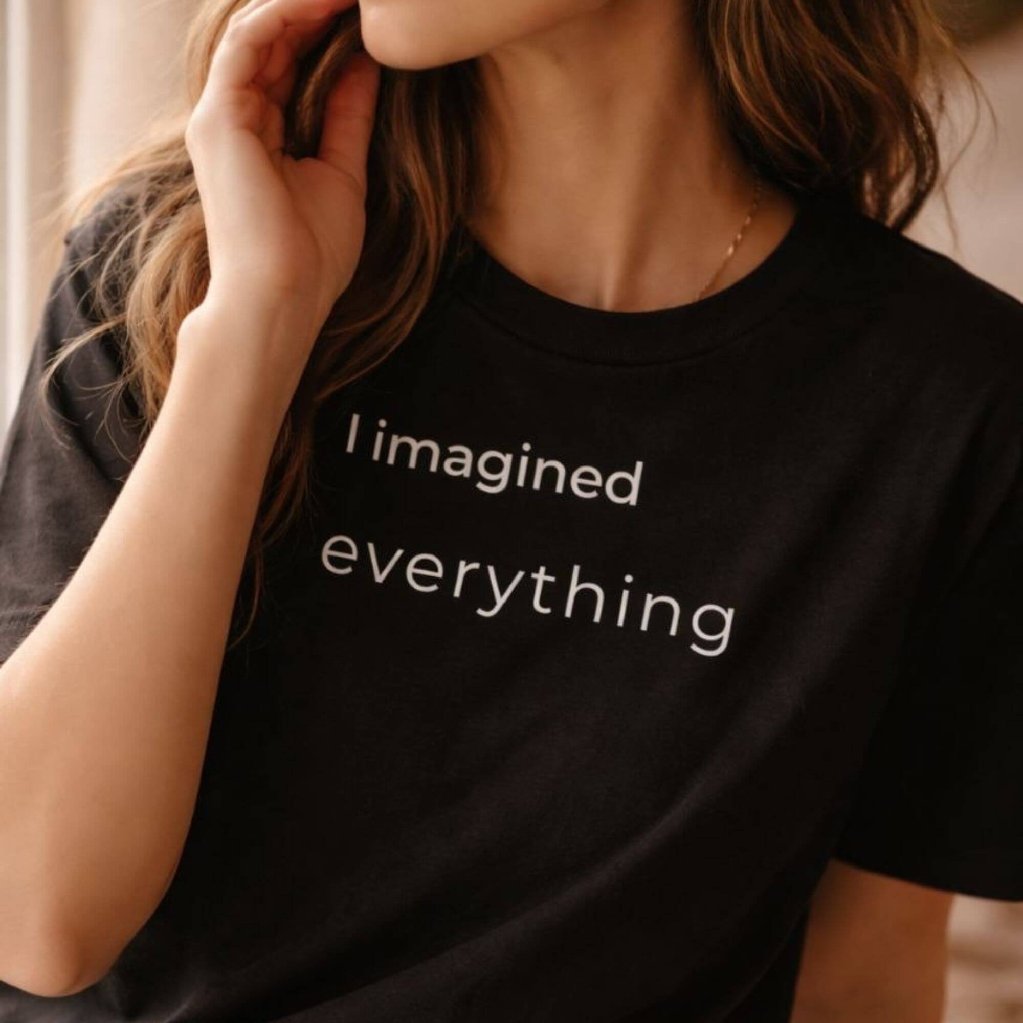 Close-up of black slogan T-shirt "I imagined everything" on female model