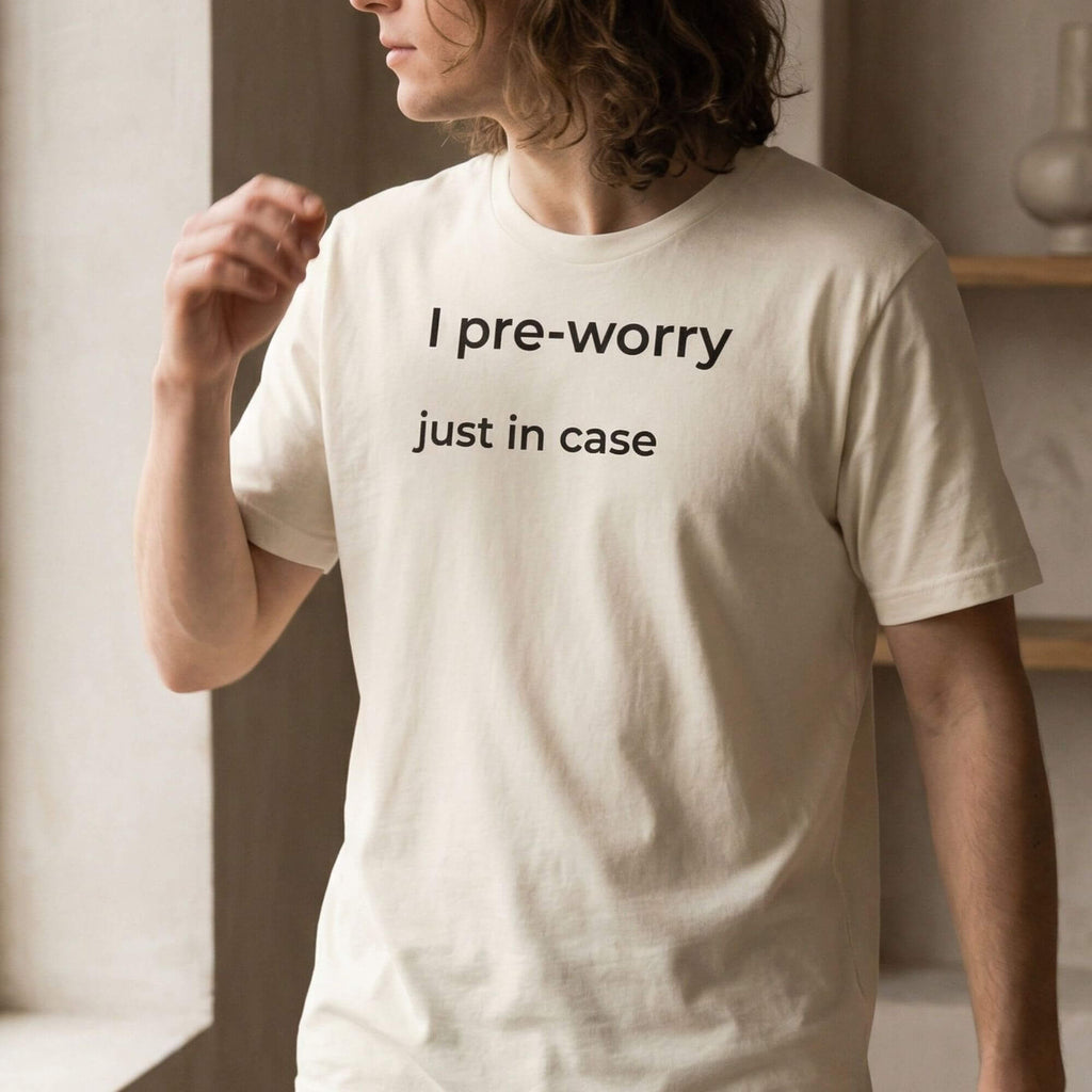 Man wearing beige minimalist T-shirt with "I pre-worry just in case" text
