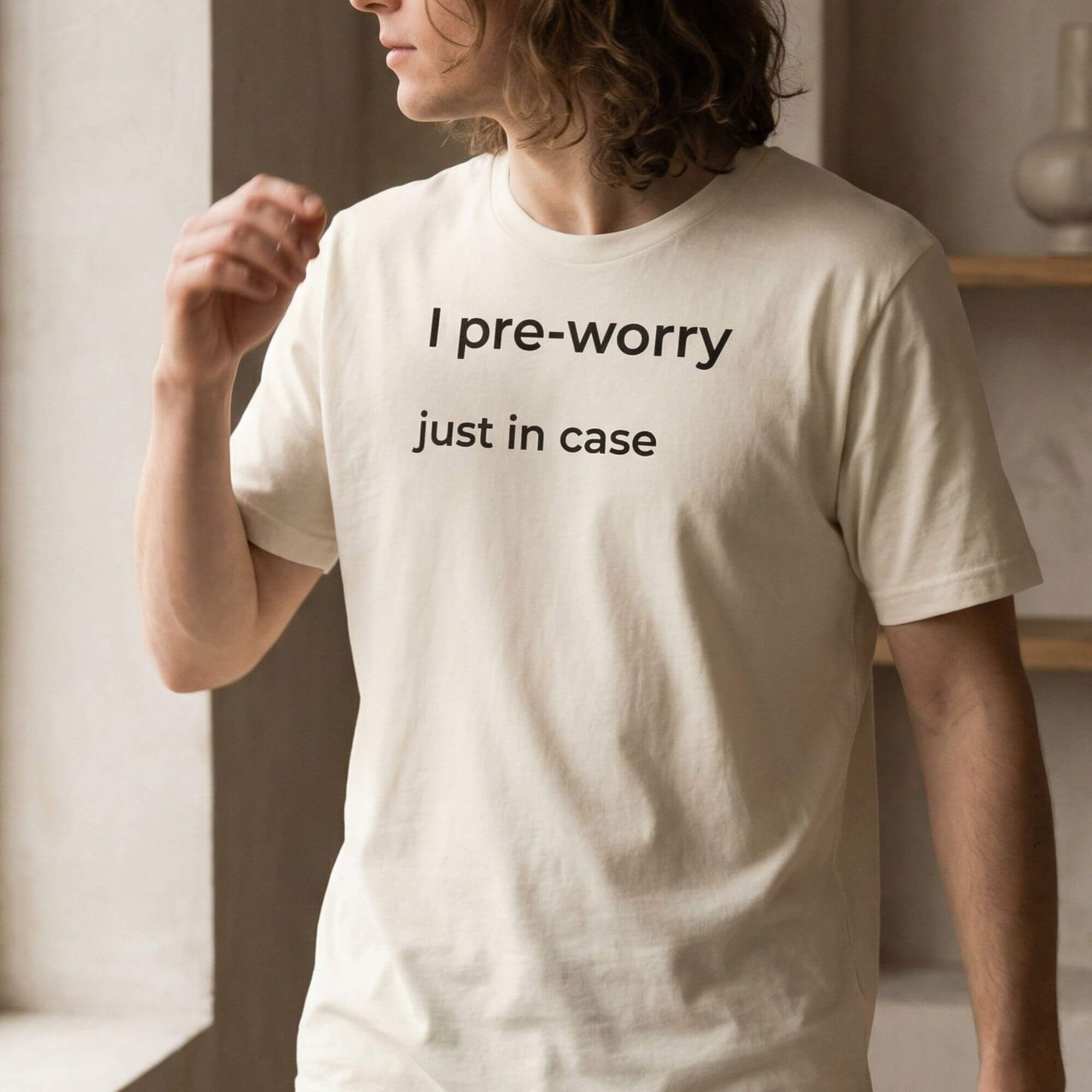 Man wearing beige minimalist T-shirt with "I pre-worry just in case" text