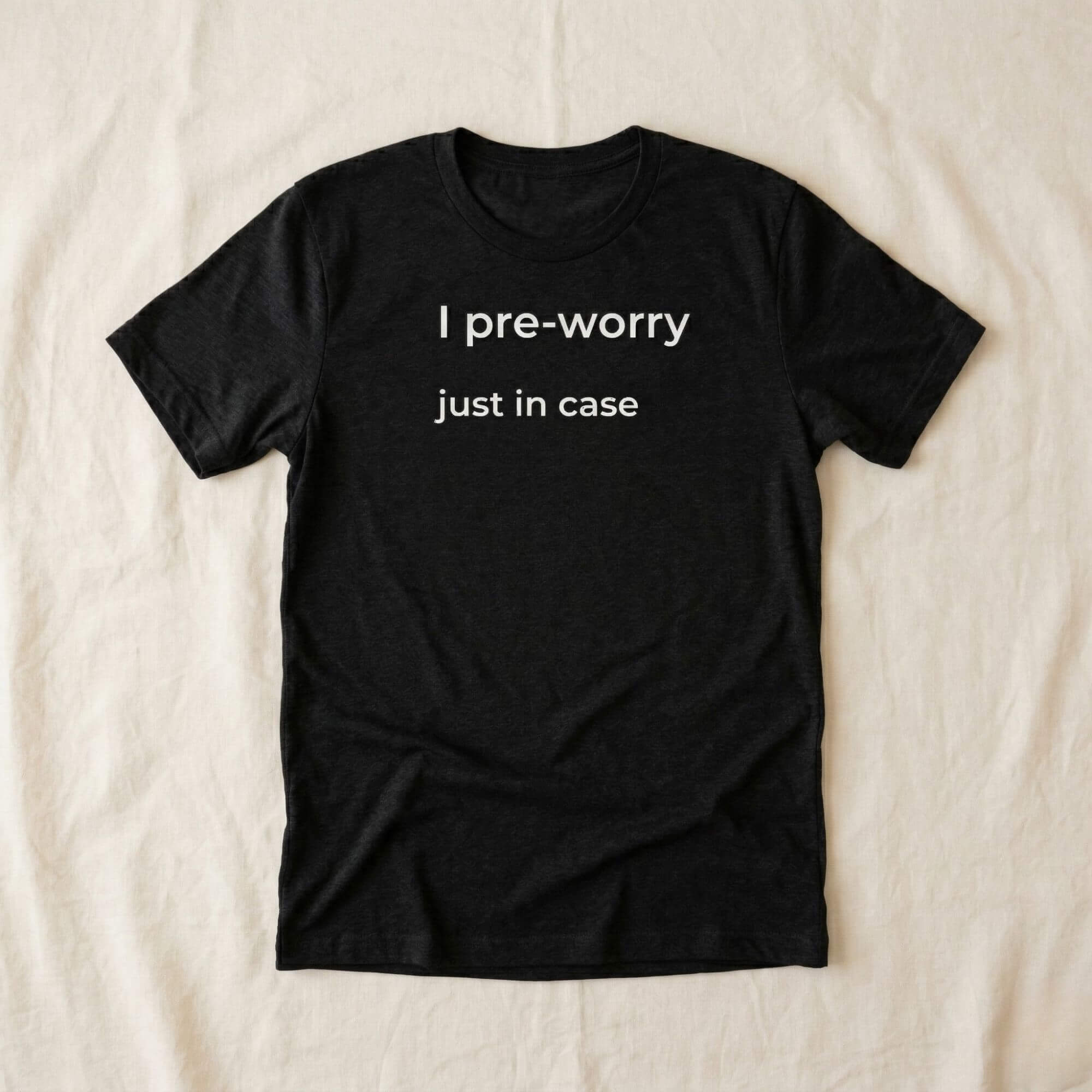 Black T-shirt with "I pre-worry just in case" text, minimalist design