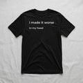 Black graphic t-shirt with “I made it worse in my head” text laid flat on soft neutral fabric