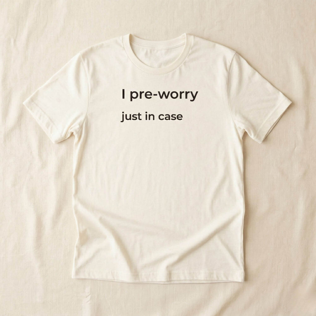 Beige T-shirt with "I pre-worry just in case" text, minimalist design