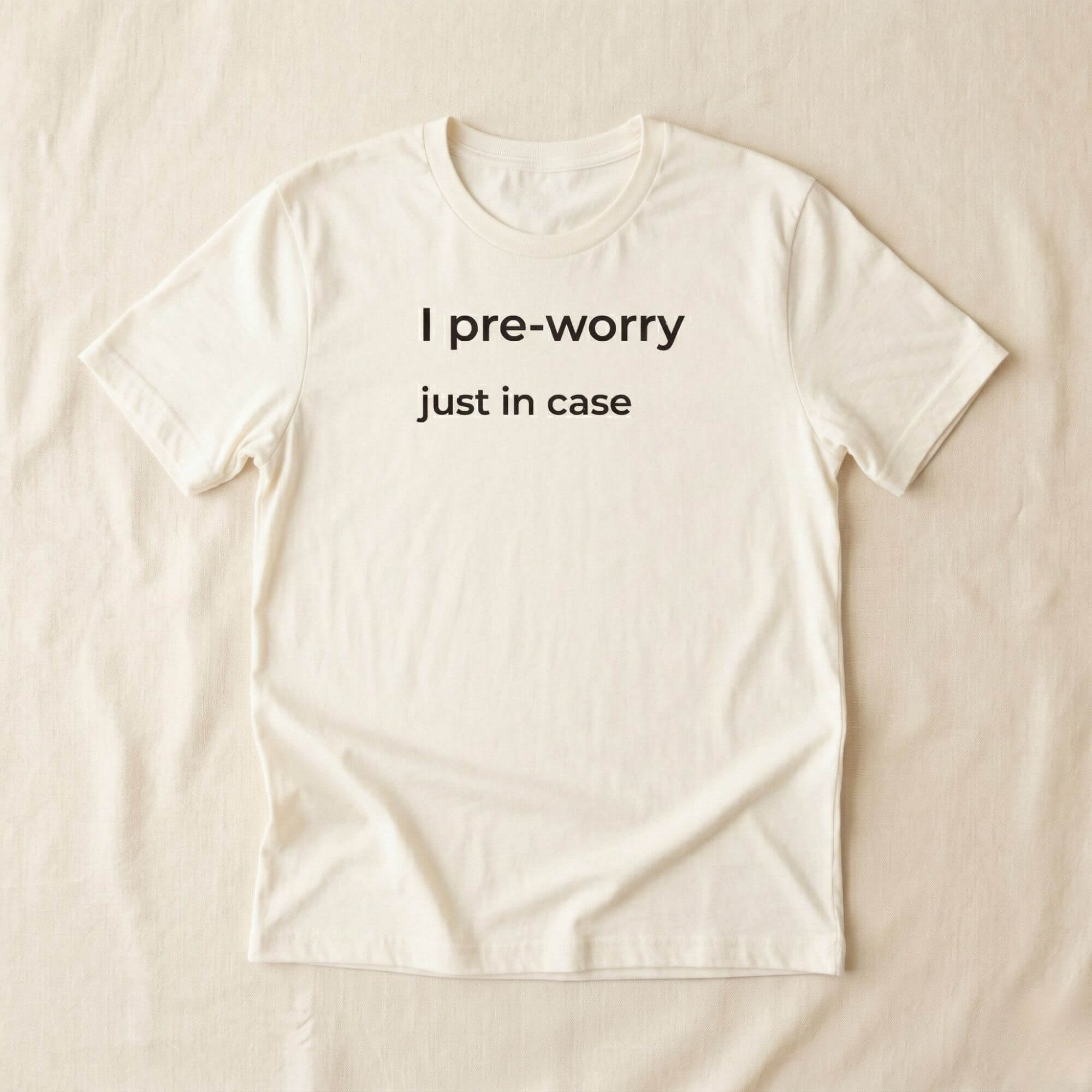 Beige T-shirt with "I pre-worry just in case" text, minimalist design