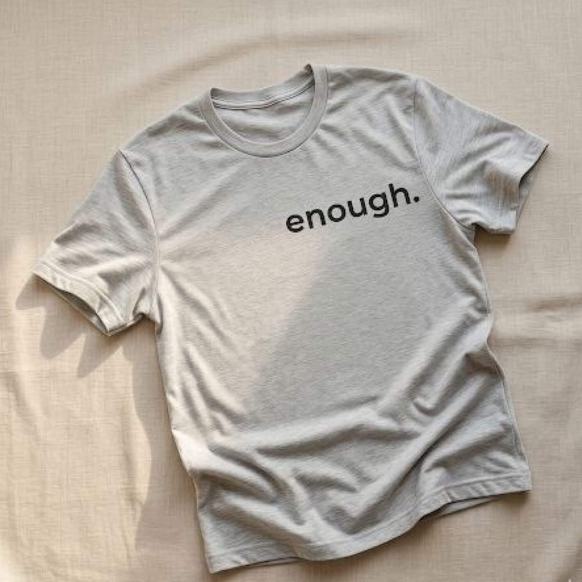 minimalist enough t-shirt gray flat lay soft aesthetic neutral background simple typography tee