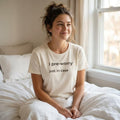 woman wearing i pre-worry just in case cream t-shirt sitting on bed by window — text & tone