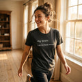 woman walking in my brain has no dark mode dark grey tee — natural light — text & tone