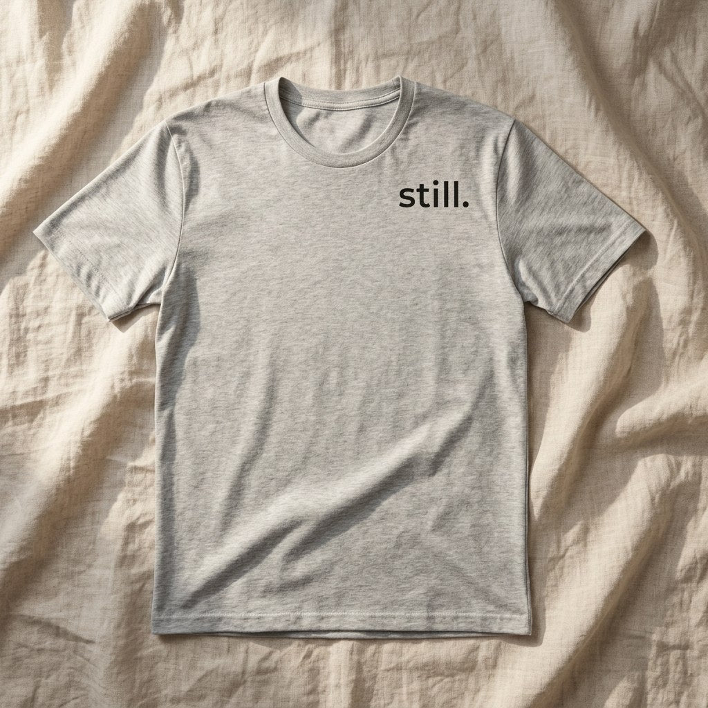 still. light grey t-shirt flat lay — minimalist tee — text & tone