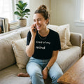 woman laughing on phone wearing tired of my mind black t-shirt on sofa — text & tone
